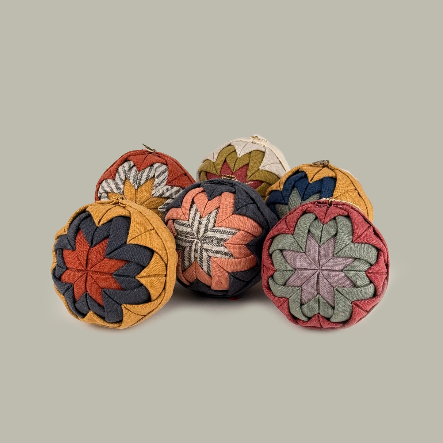 Set of colorful fabric ornaments on a light gray background